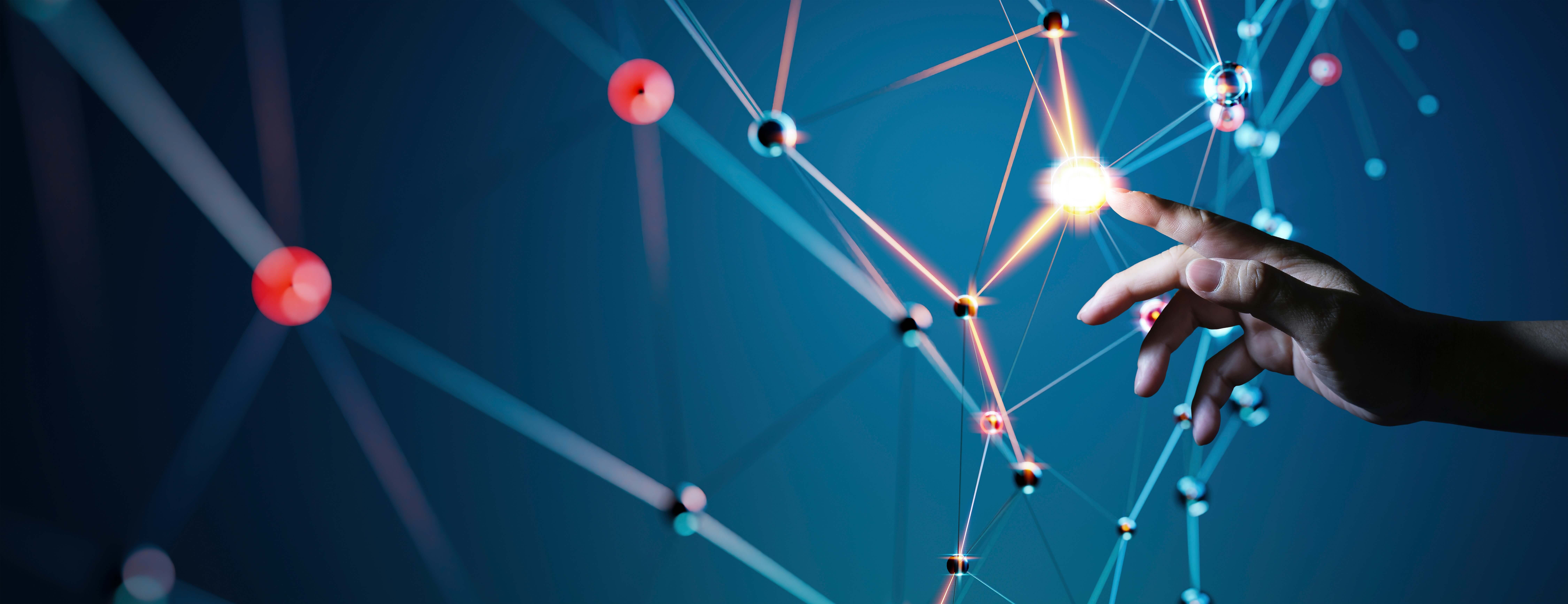 A human hand reaching towards a glowing point on a network of interconnected nodes and lines, representing technology and innovation.