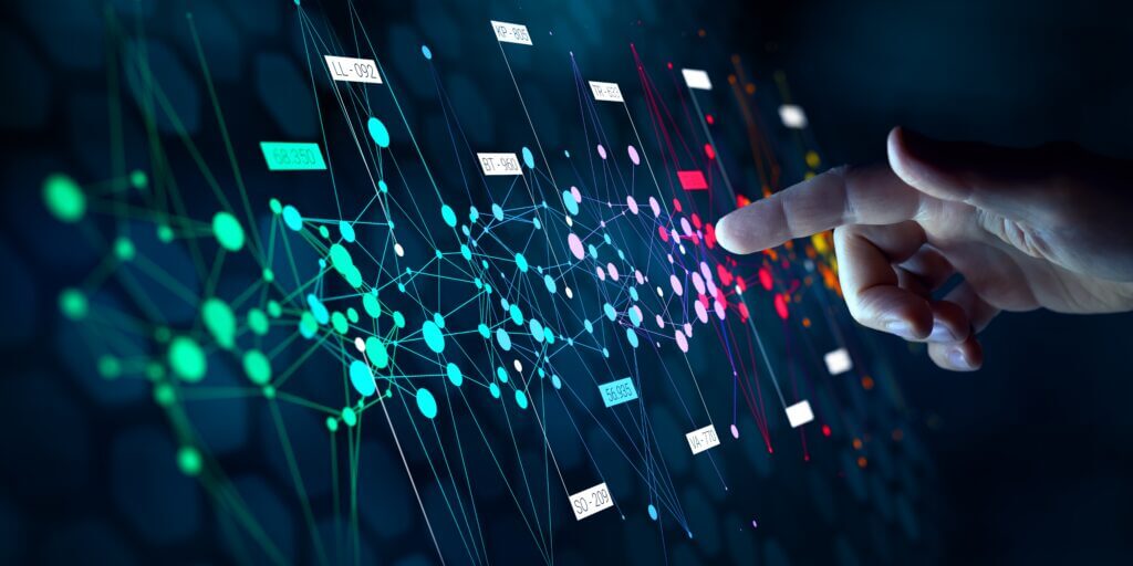 A hand is reaching out to interact with a virtual network of colorful nodes and lines, representing data connections and technology, against a dark background.